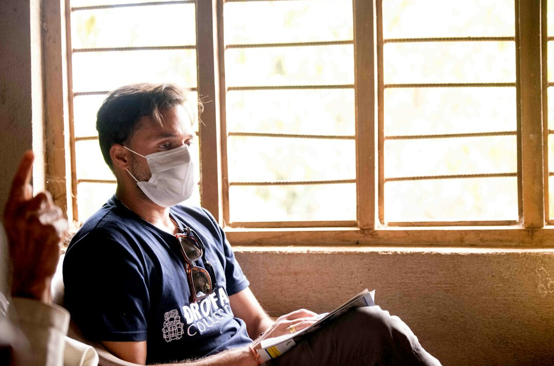 Healthcare worker using a tablet at a hospital reception counter