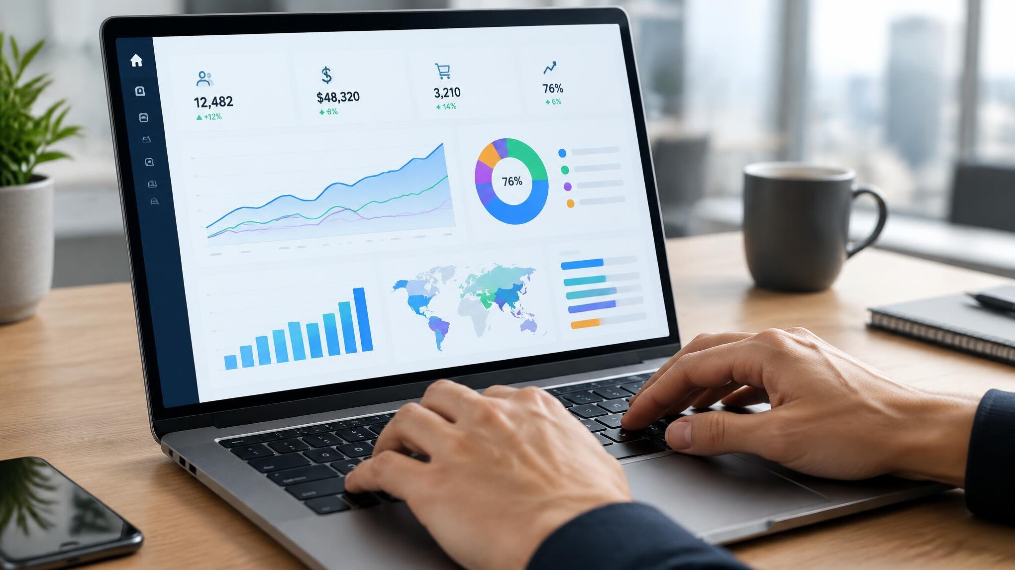 Close-up of hands typing on a laptop showing an analytics dashboard
