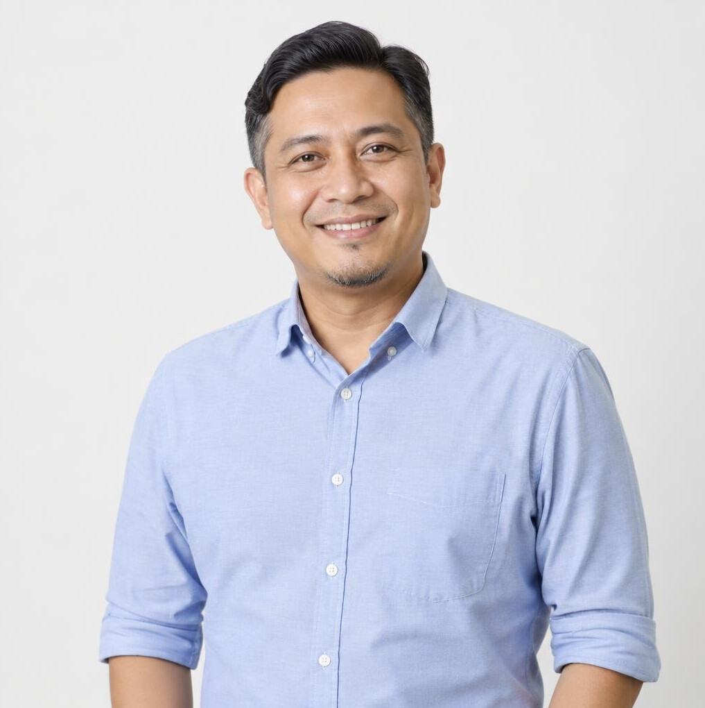 Portrait of a Singaporean Malay male founder and CEO smiling in an office